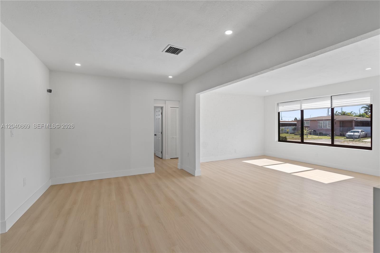31 West 64th Street Hialeah, FL 33012 - Photo 13 of 49 an empty room with wooden floor and windows