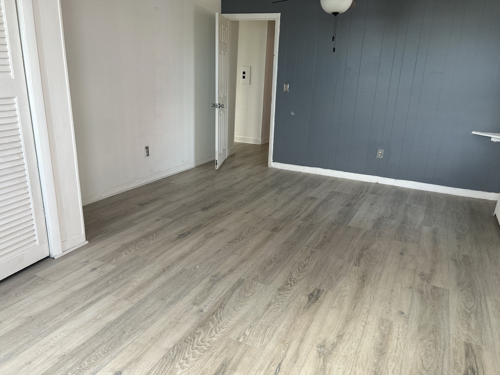 332 Revere Beach Boulevard, Unit 7 Revere, MA 02151 - Photo 6 of 8 a view of an empty room with wooden floor