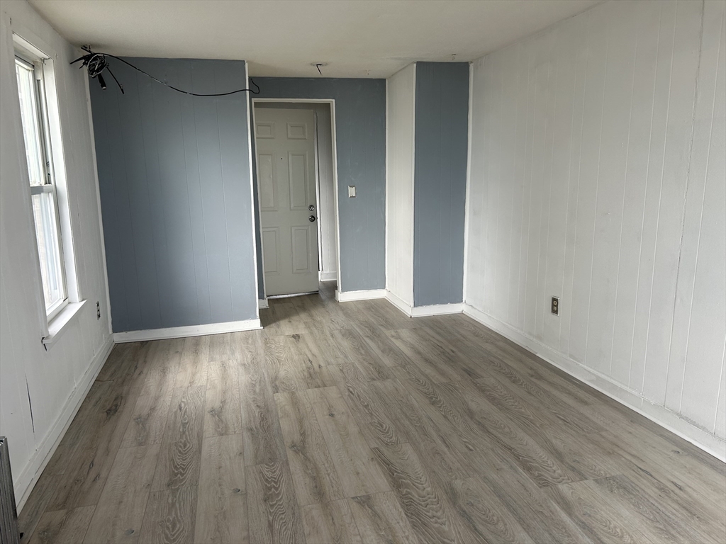 332 Revere Beach Boulevard, Unit 7 Revere, MA 02151 - Photo 7 of 8 an empty room with wooden floor and windows