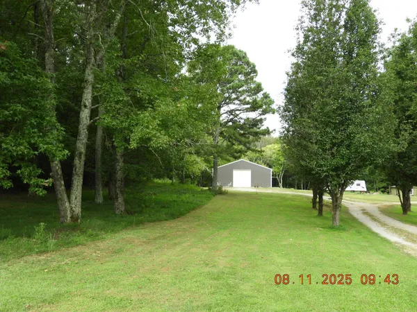 a backyard of a house with lots of green space and garden