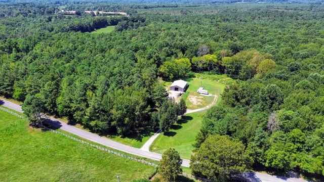 a backyard of a house with lots of green space and outdoor seating