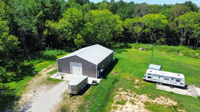 a view of a lake in middle of green field