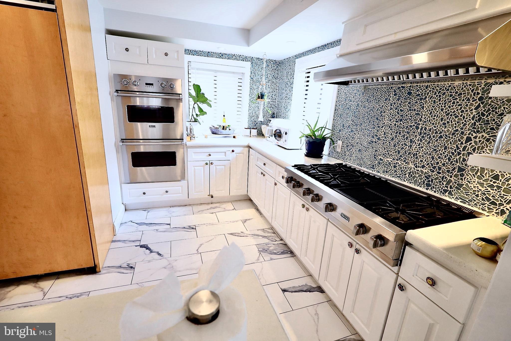 701 Lombard Street Philadelphia, PA 19147 - Photo 11 of 59 a kitchen with stainless steel appliances a stove a sink and a refrigerator