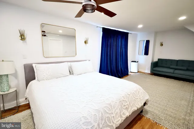 a spacious bedroom with a bed and a chandelier