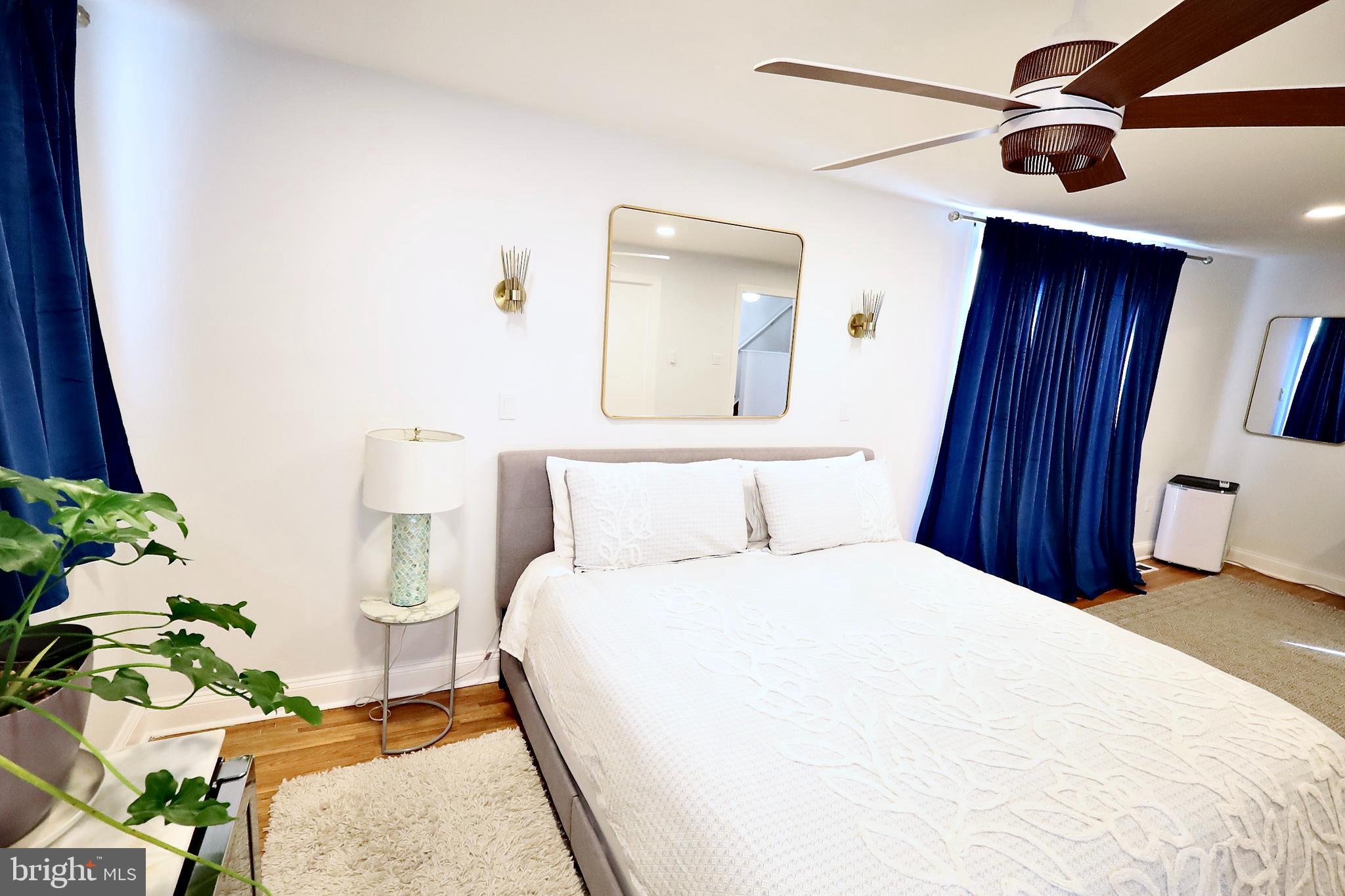 701 Lombard Street Philadelphia, PA 19147 - Photo 17 of 59 a bedroom with a bed and a chandelier