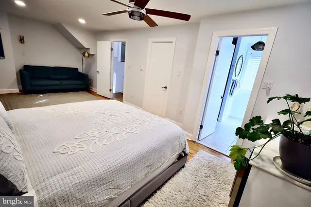 a bedroom with a bed potted plant with a mirror