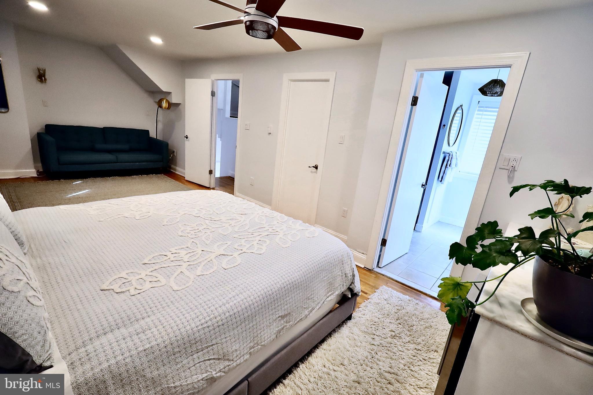 701 Lombard Street Philadelphia, PA 19147 - Photo 22 of 59 a bedroom with a bed potted plant with a mirror