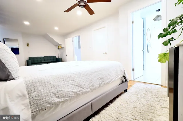 a large bed sitting in a spacious bedroom next to a window