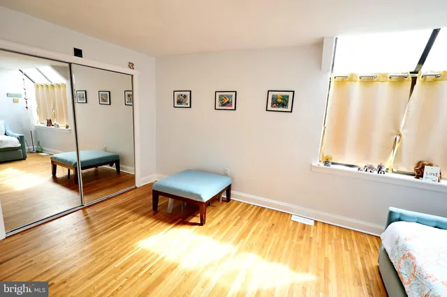 a living room with a bed furniture and a window
