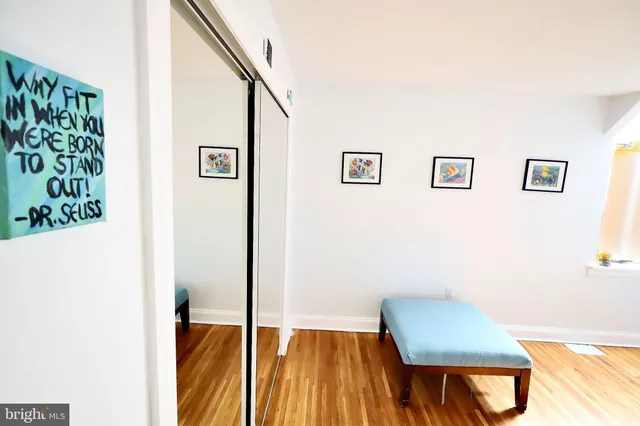 a bathroom with a sink and mirror with bathtub