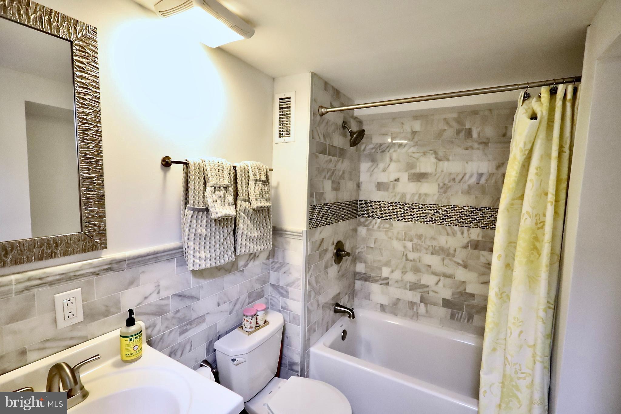 701 Lombard Street Philadelphia, PA 19147 - Photo 28 of 59 a bathroom with a bathtub and a shower
