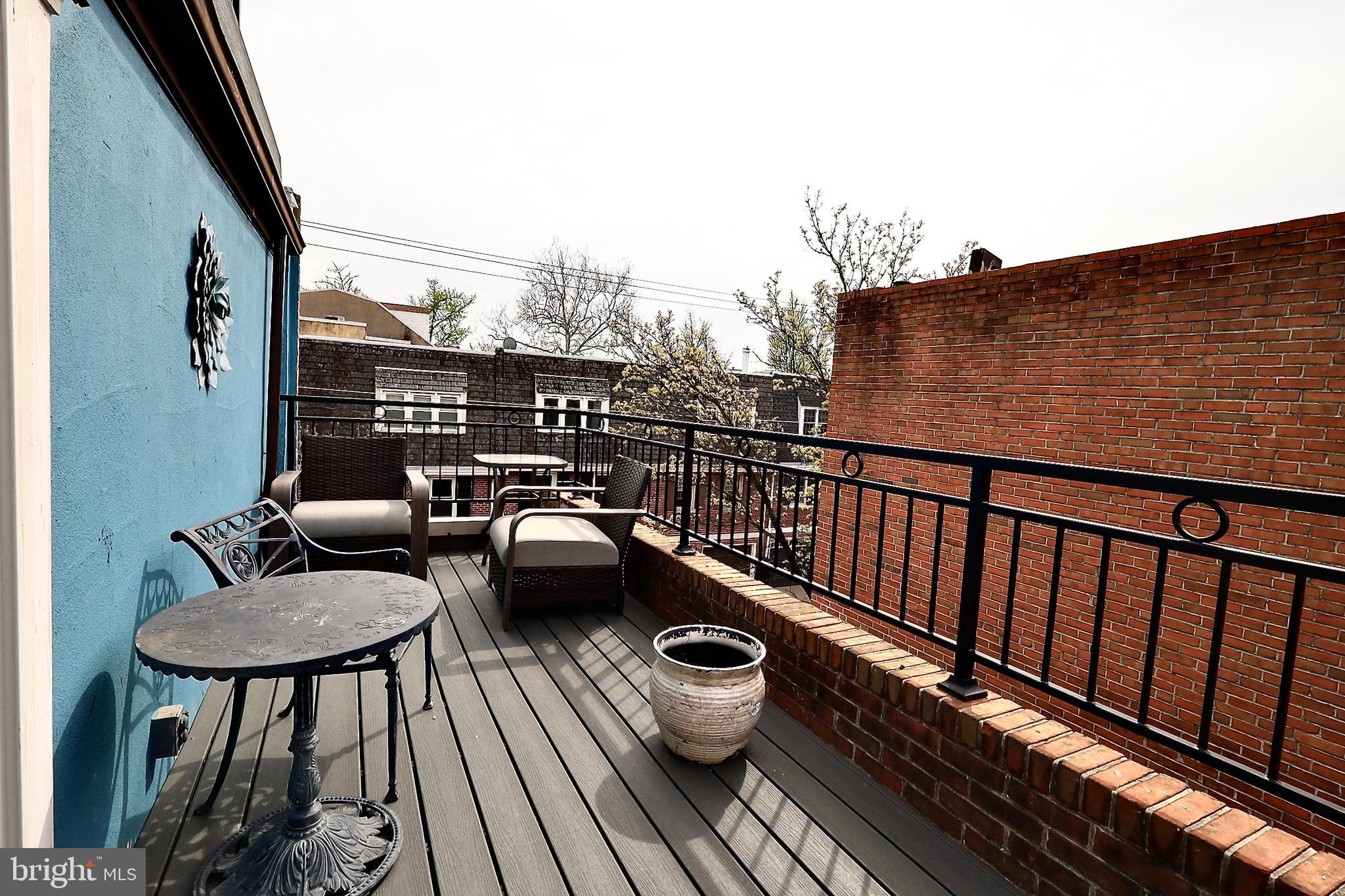 701 Lombard Street Philadelphia, PA 19147 - Photo 39 of 59 a balcony with wooden floor table and chairs