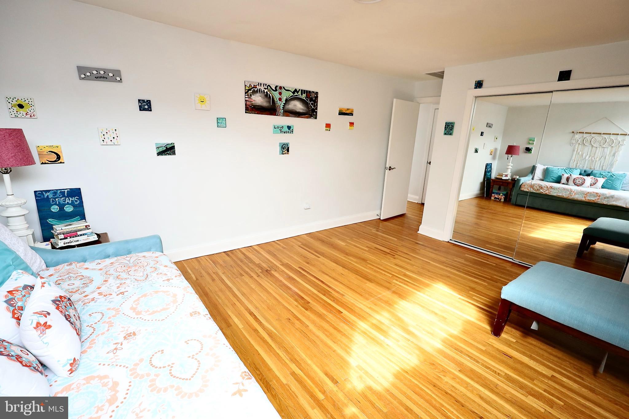 701 Lombard Street Philadelphia, PA 19147 - Photo 47 of 59 a bedroom with a bed and wooden floor