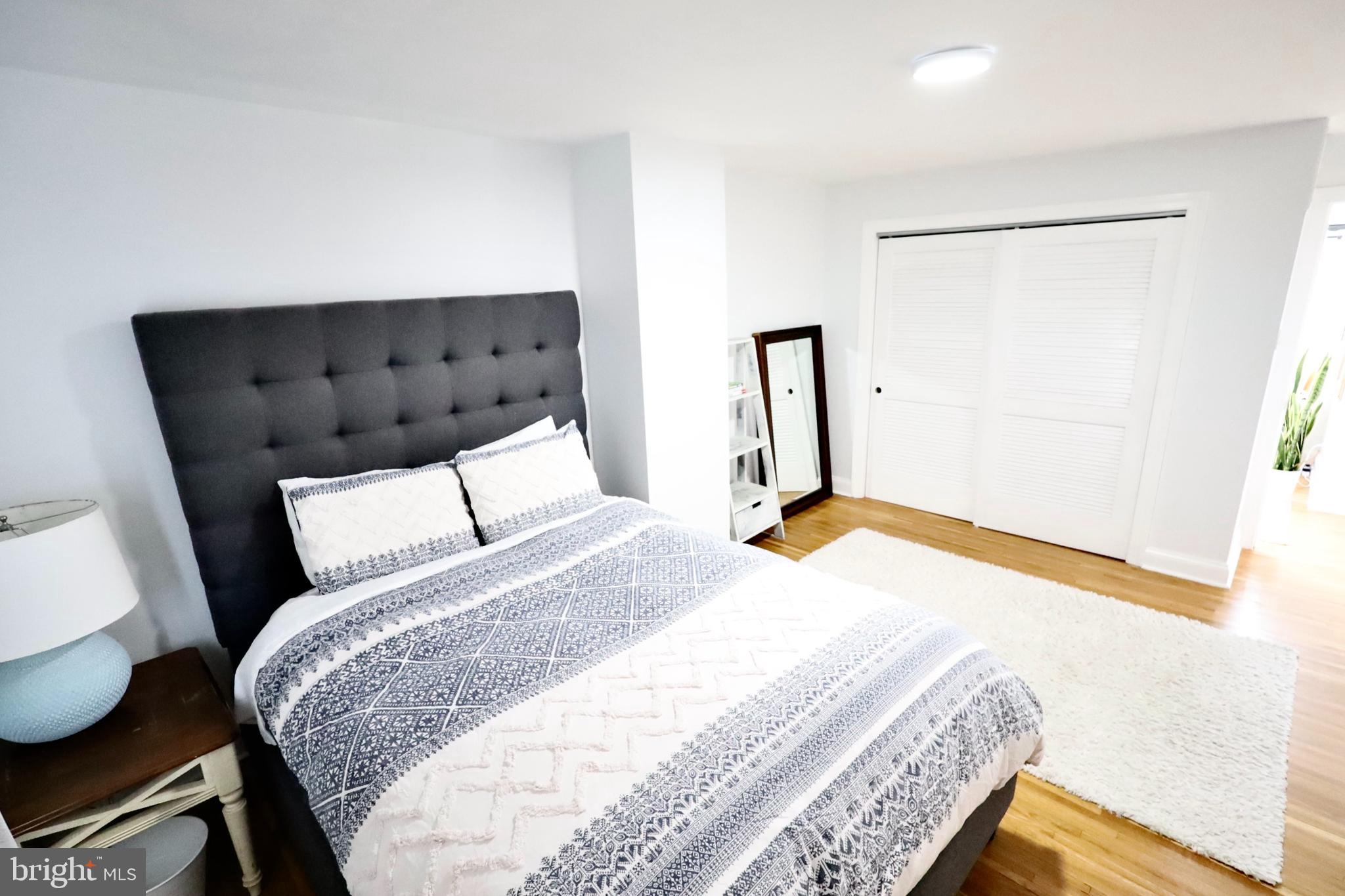 701 Lombard Street Philadelphia, PA 19147 - Photo 49 of 59 a bedroom with a bed and wooden floor