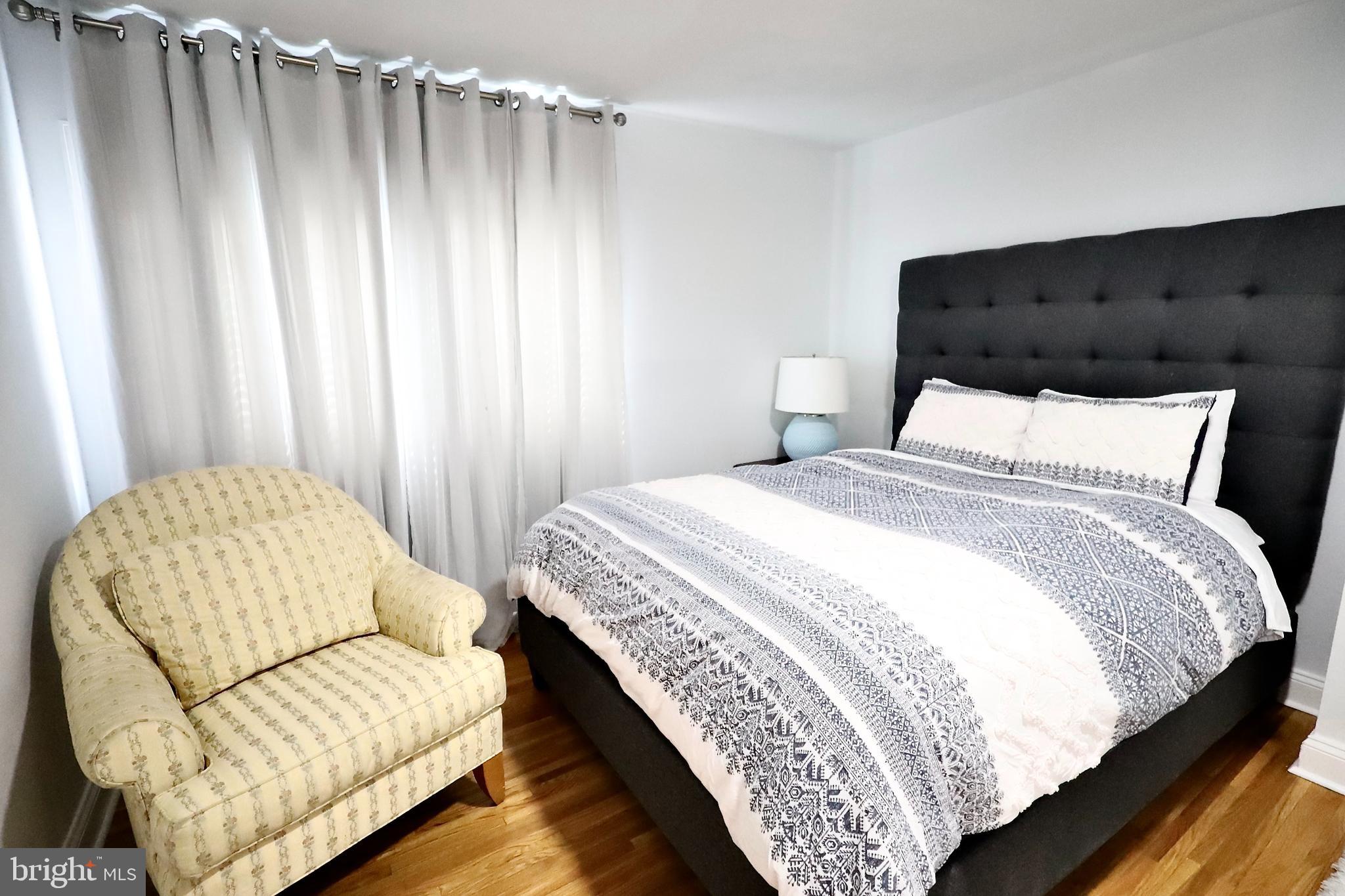 701 Lombard Street Philadelphia, PA 19147 - Photo 50 of 59 a bedroom with a bed and curtain