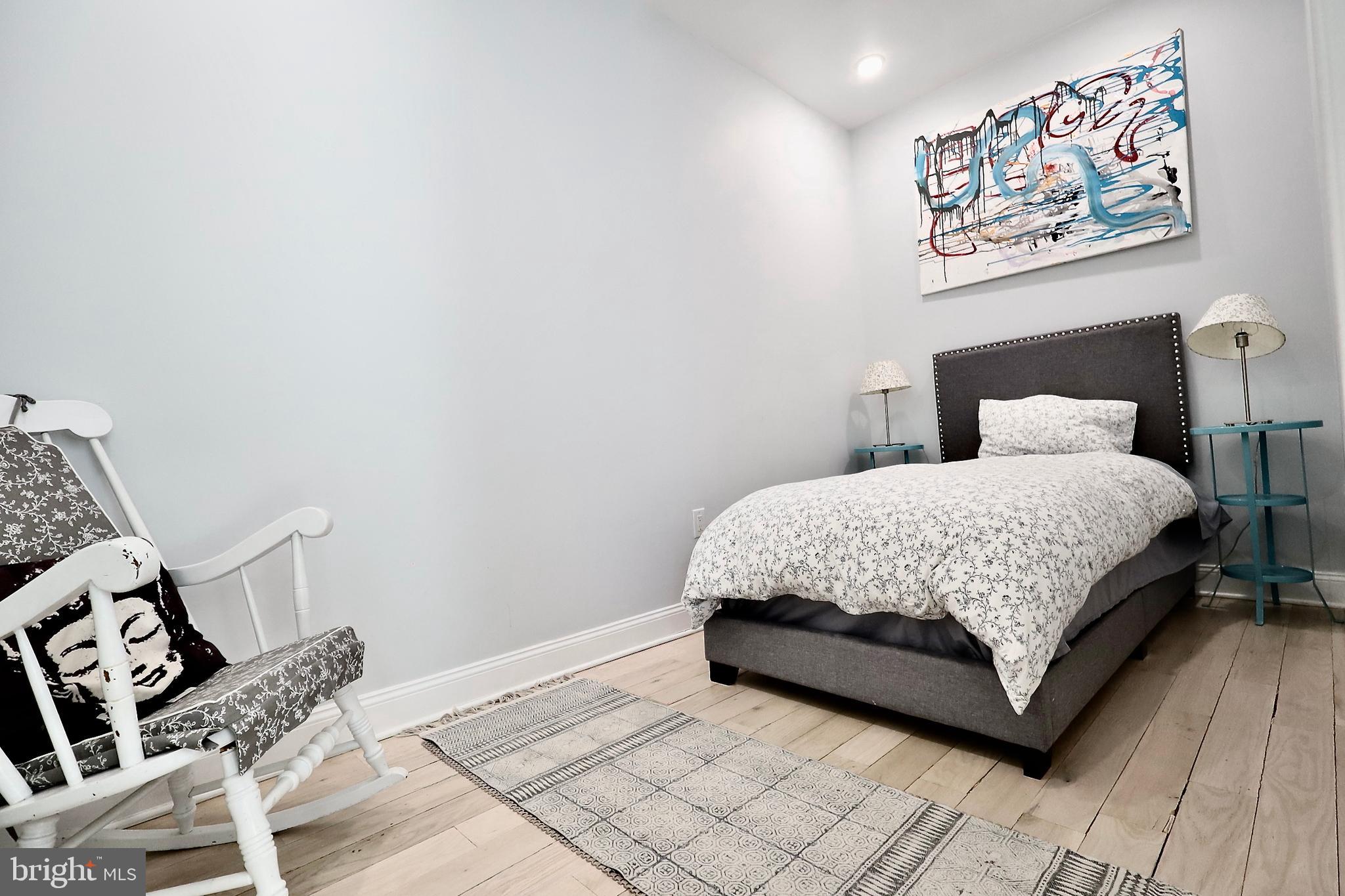701 Lombard Street Philadelphia, PA 19147 - Photo 55 of 59 a bedroom with a bed painting on the wall and a rug