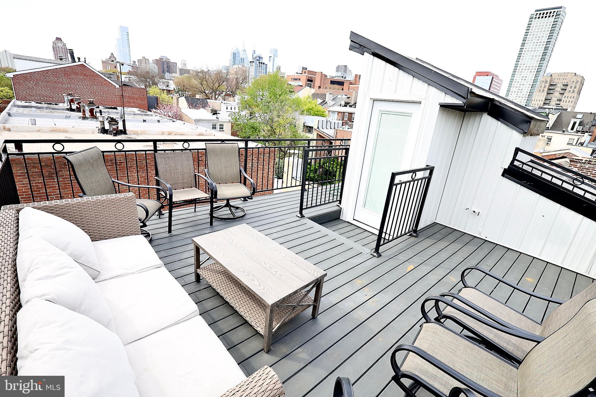 701 Lombard Street Philadelphia, PA 19147 - Photo 57 of 59 a view of a roof deck with table and chairs