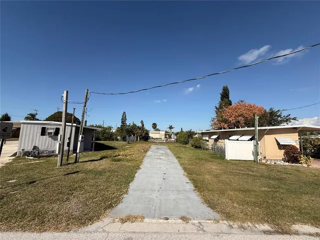 a view of a swimming pool with a yard