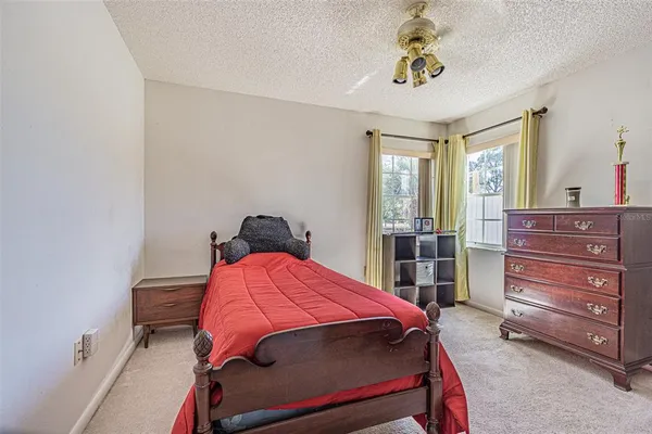 a bedroom with a bed and a dresser in it