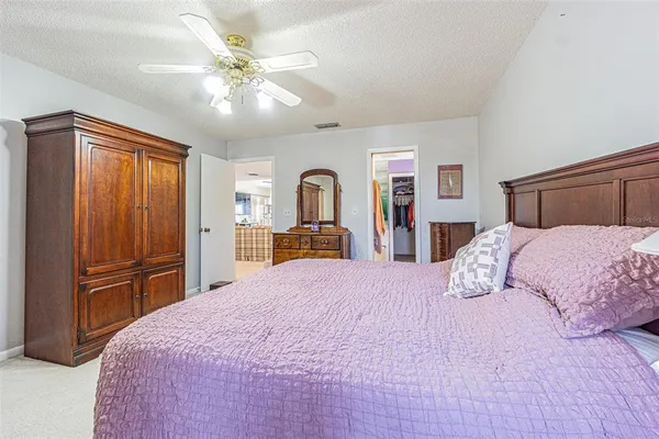 a bedroom with a large bed and dresser
