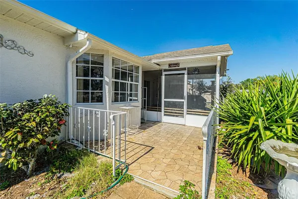 a view of front door and potted plants