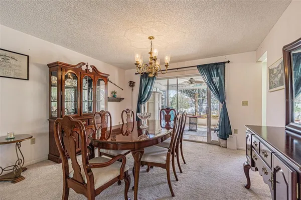 a view of a dining room with furniture and chandelier