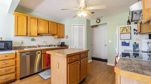 a kitchen with stainless steel appliances granite countertop a stove and a sink