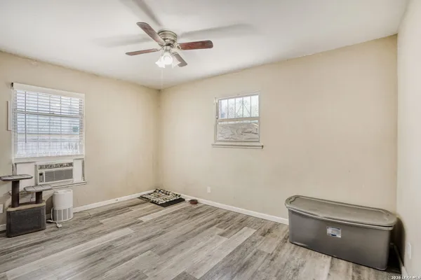 a view of room with a ceiling fan and window