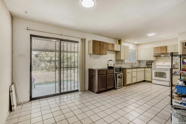 a kitchen with stainless steel appliances granite countertop a refrigerator sink and cabinets