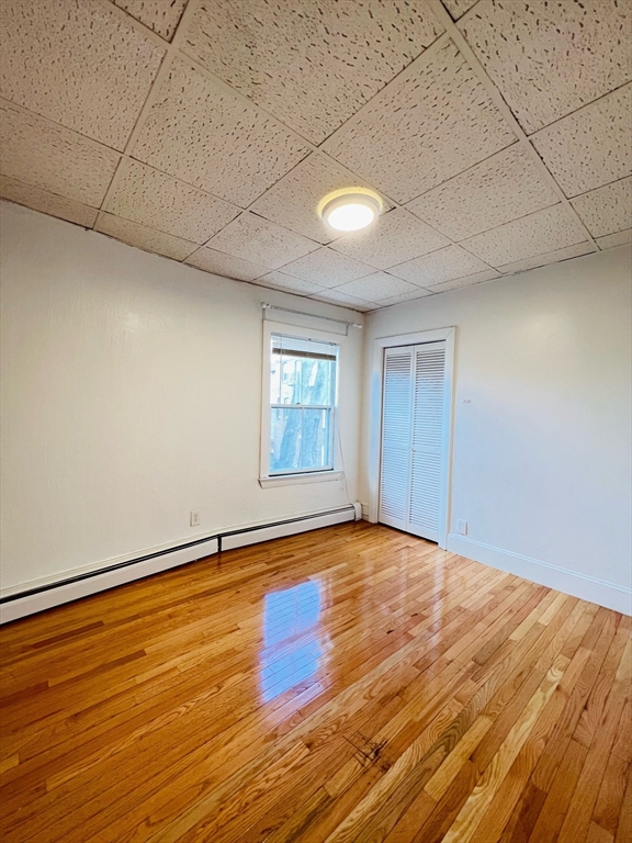11 Franklin Street, Unit 3 Boston, MA 02129 - Photo 15 of 19 a view of an empty room with window and wooden floor