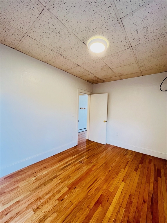11 Franklin Street, Unit 3 Boston, MA 02129 - Photo 17 of 19 a view of empty room with wooden floor
