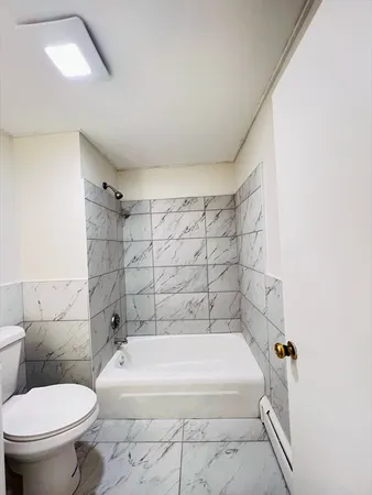 a bathroom with a bathtub and toilet
