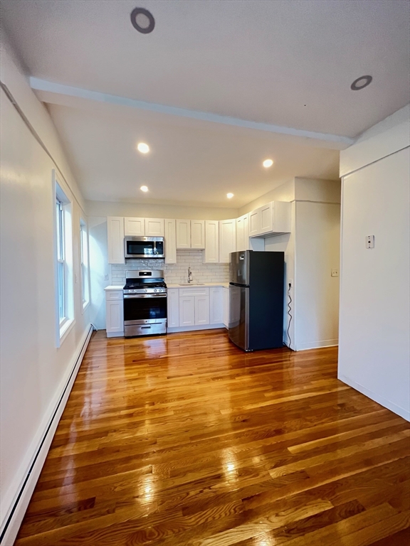 11 Franklin Street, Unit 3 Boston, MA 02129 - Photo 4 of 19 a kitchen with stainless steel appliances granite countertop a refrigerator and a stove top oven