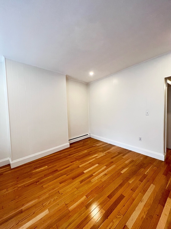 11 Franklin Street, Unit 3 Boston, MA 02129 - Photo 7 of 19 a view of an empty room with wooden floor