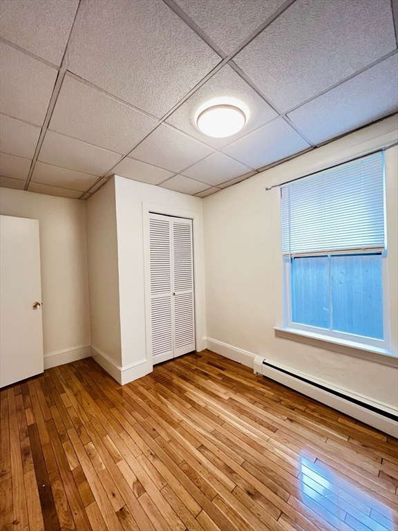 11 Franklin Street, Unit 3 Boston, MA 02129 - Photo 8 of 19 a view of an empty room with wooden floor and a window