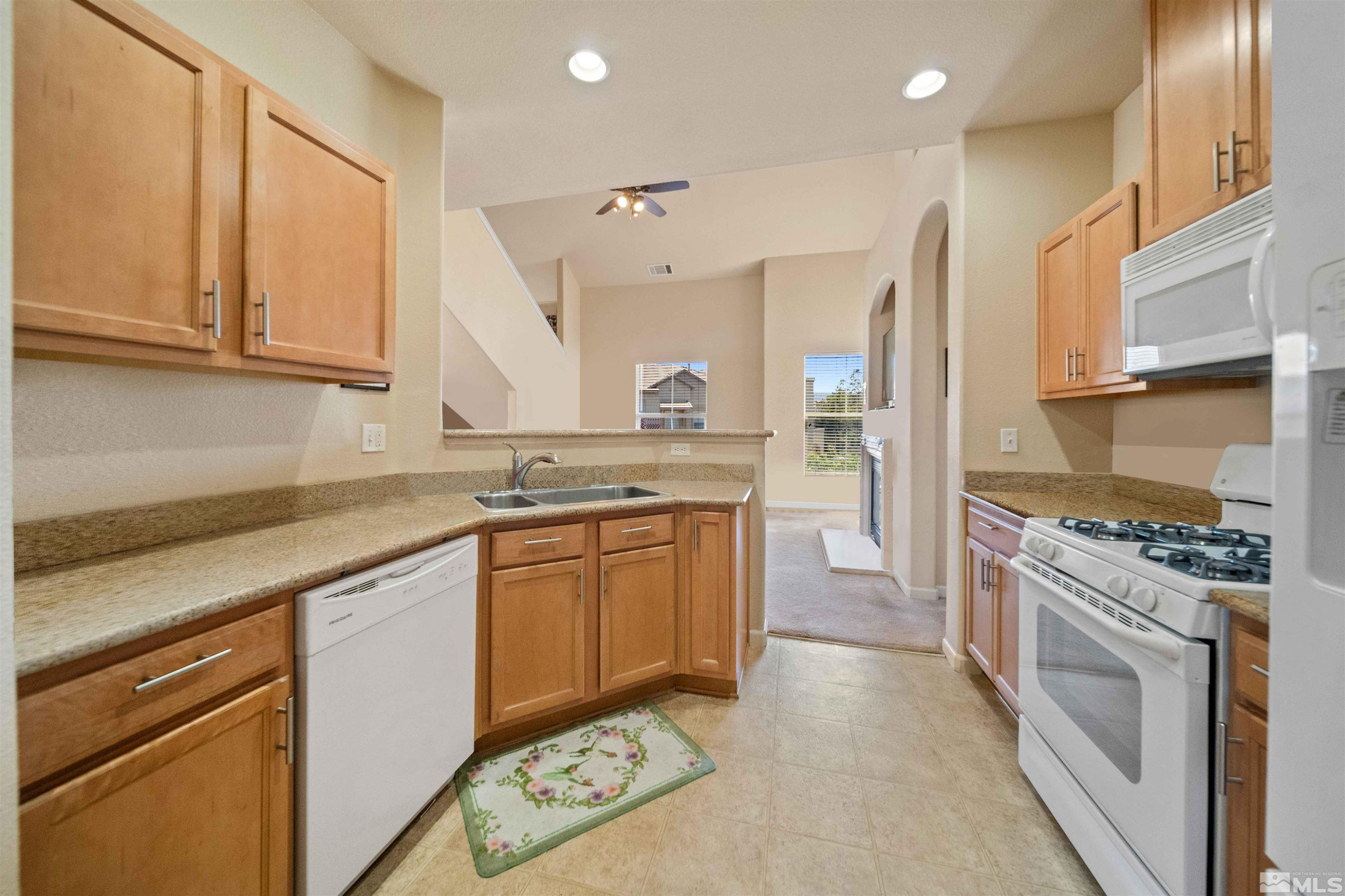 17000 Wedge Parkway Reno, NV 89511 - Photo 13 of 35 a kitchen with granite countertop a stove sink and cabinets
