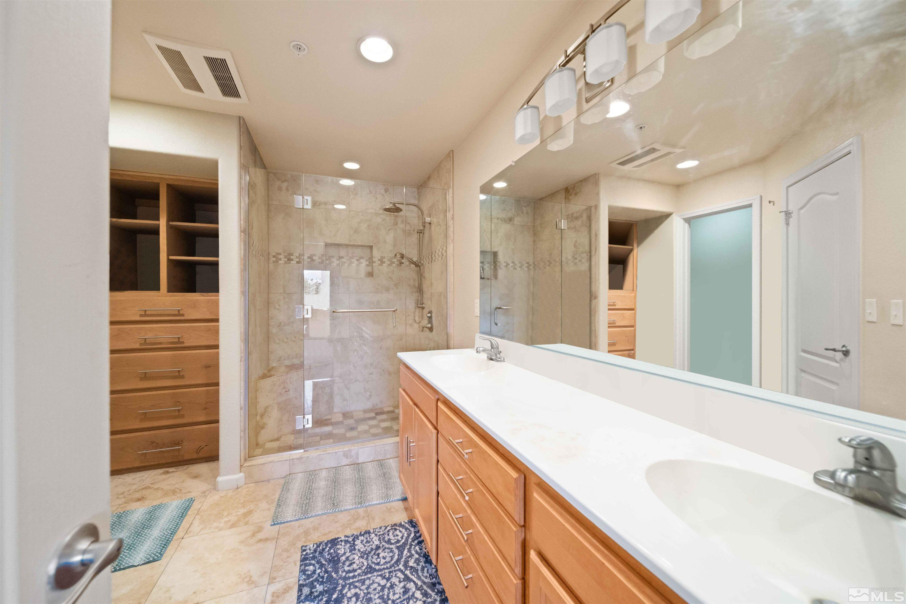 17000 Wedge Parkway Reno, NV 89511 - Photo 18 of 35 a spacious bathroom with a sink a shower and a mirror