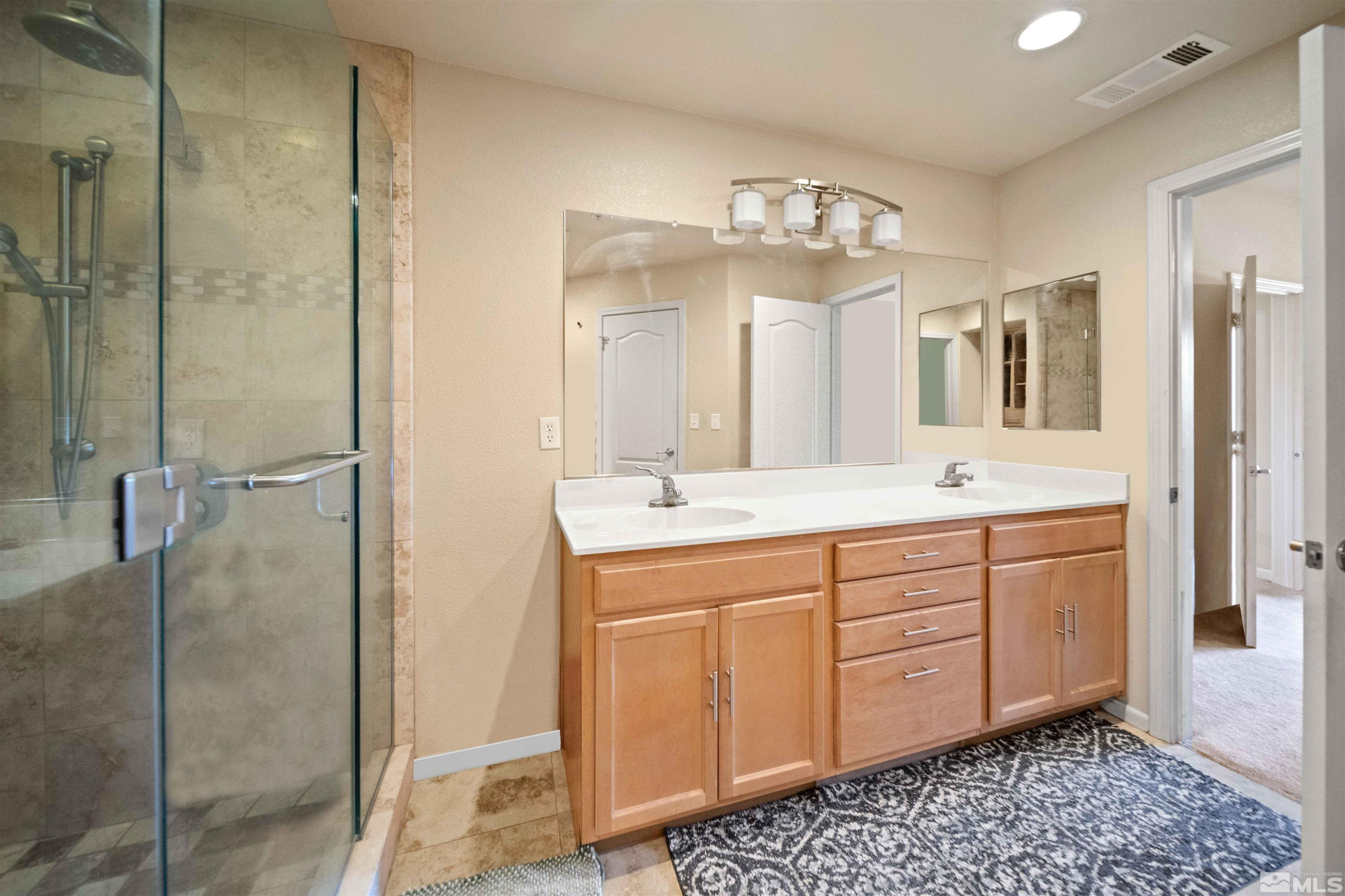 17000 Wedge Parkway Reno, NV 89511 - Photo 19 of 35 a bathroom with a double vanity sink mirror and shower