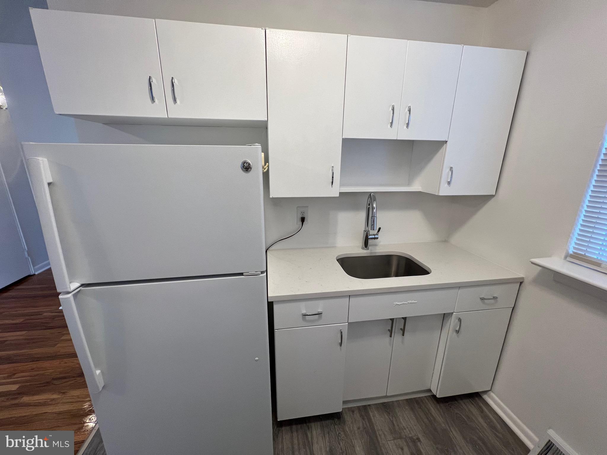 112 Clement Road, Unit B Oreland, PA 19075 - Photo 11 of 19 a view of cabinets and wooden floor