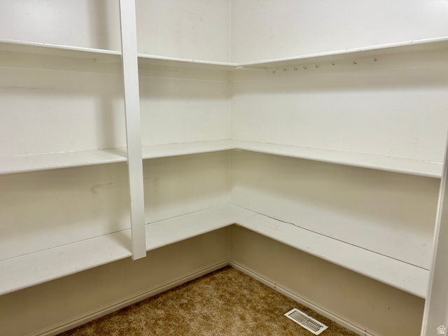 672 West 720 South Logan, UT 84321 - Photo 15 of 15 Spacious pantry featuring multiple white built-in shelves, corner shelving, and a floor vent