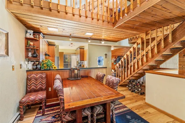 a kitchen with stainless steel appliances granite countertop a refrigerator a stove and a wooden floors