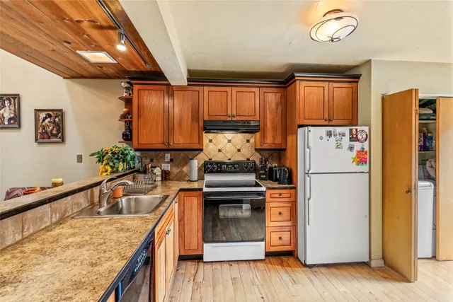 a kitchen with stainless steel appliances granite countertop a stove and a sink