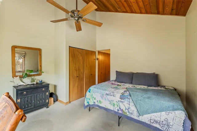 a bathroom with a granite countertop sink a mirror and shower