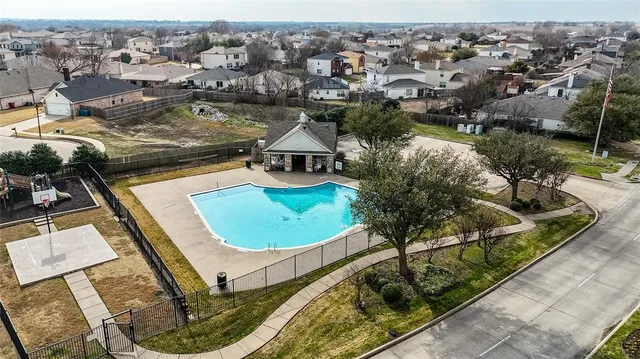 an aerial view of a house with swimming pool and ocean view