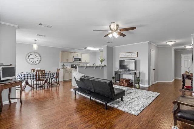 a living room with furniture and wooden floor