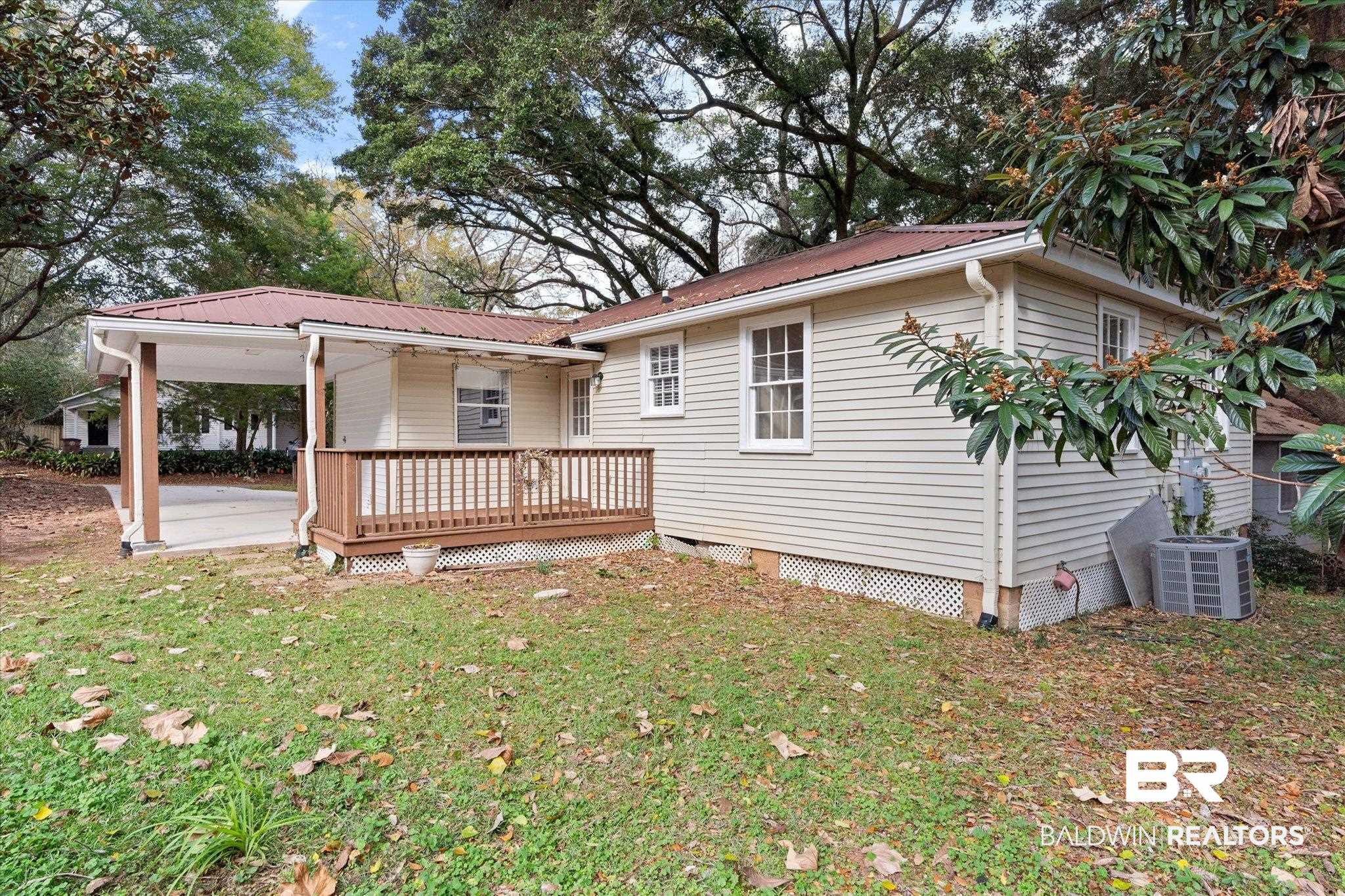 5113 Norton Lane Mobile, AL 36608 - Photo 17 of 20 Rear view of house with a yard, central AC, and a deck