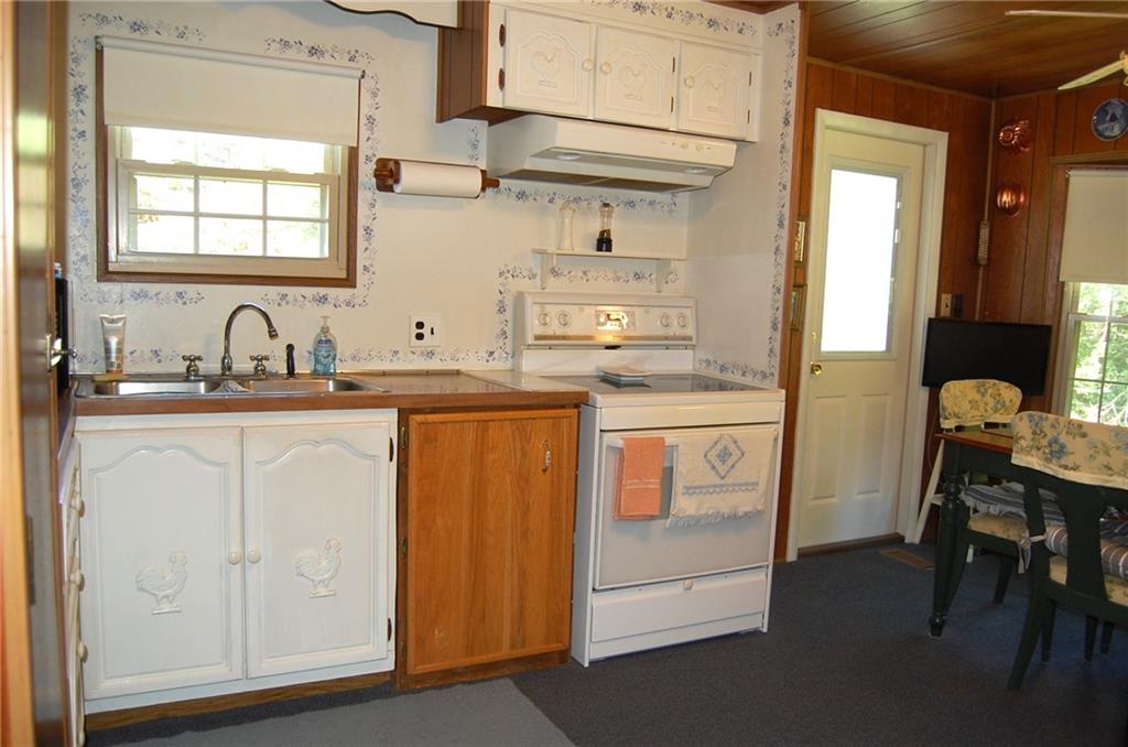 124 Gun Hill Road Wind Ridge, PA 15380 - Photo 17 of 25 a kitchen with a sink cabinets and a window