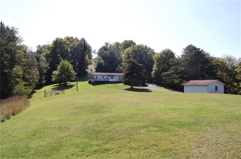124 Gun Hill Road Wind Ridge, PA 15380 - Photo 2 of 25 a view of a house with a yard and sitting area