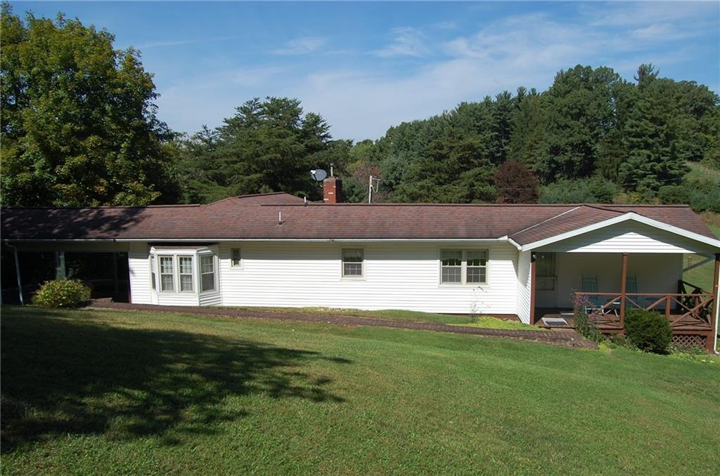 124 Gun Hill Road Wind Ridge, PA 15380 - Photo 4 of 25 a front view of a house with a yard and trees