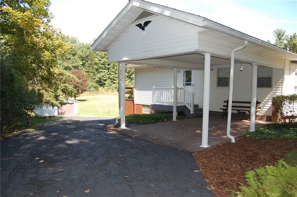 124 Gun Hill Road Wind Ridge, PA 15380 - Photo 7 of 25 a front view of a house with a yard and garage